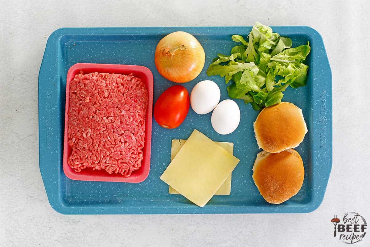 ingredients to make egg burger on a blue tray