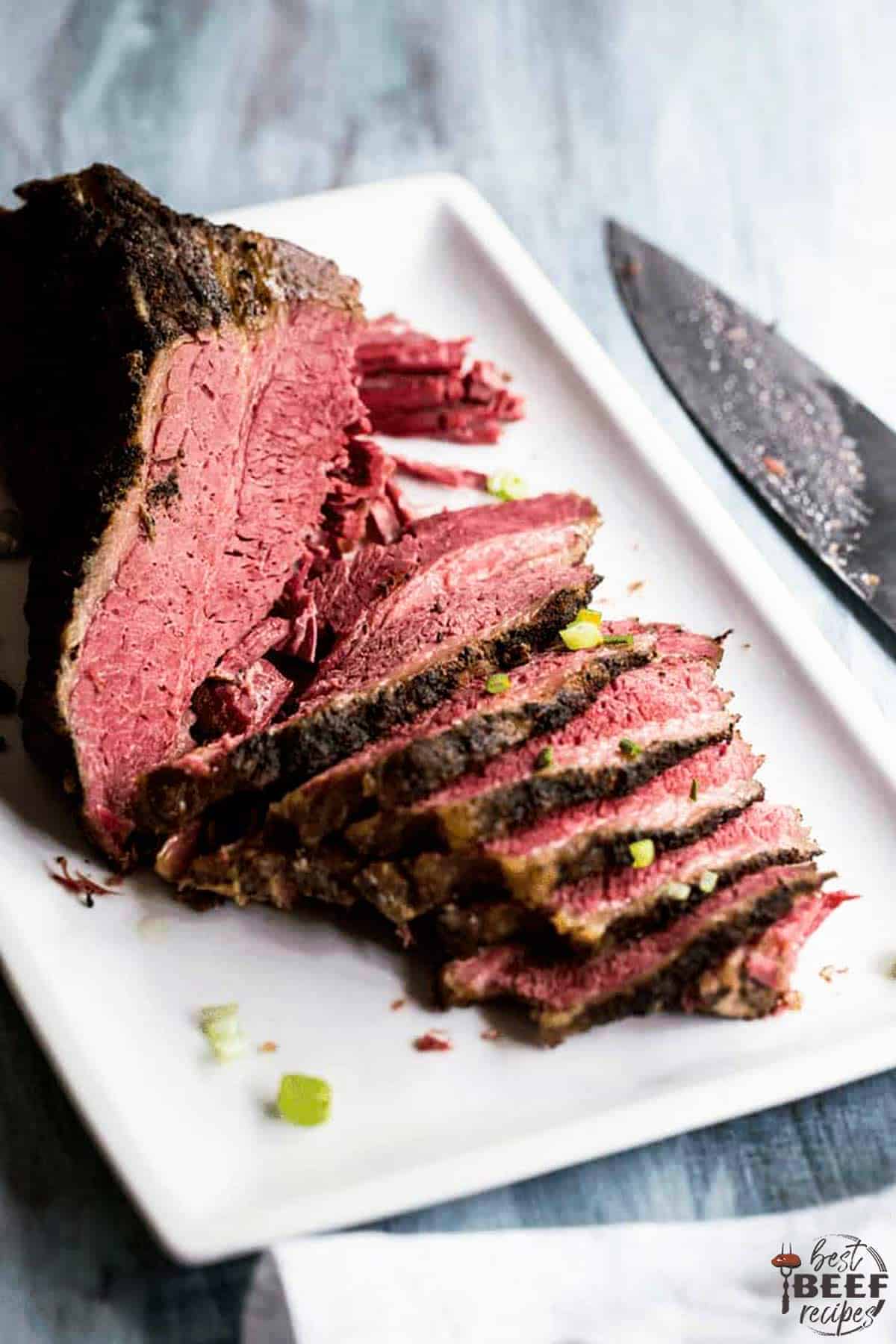 Slow cooker beef brisket sliced on a white platter