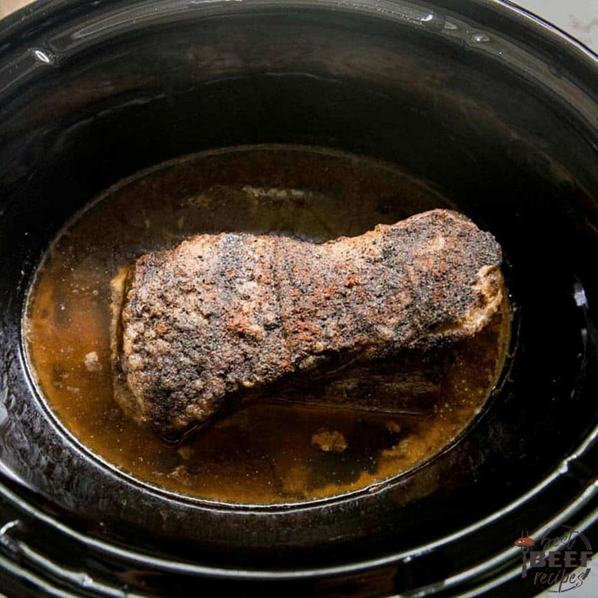 Beef brisket after slow cooking, still in cooker