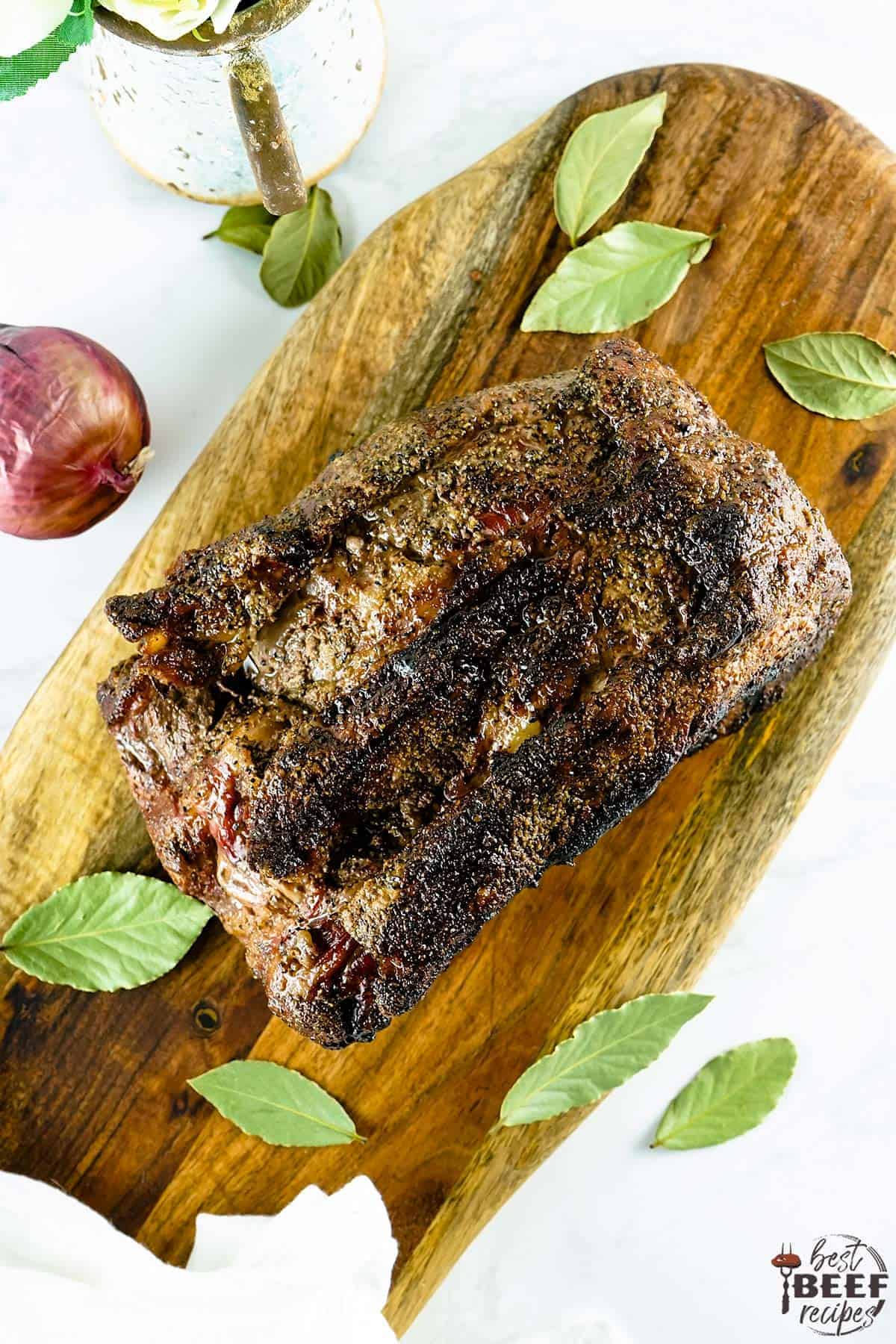 Whole smoked prime rib on a cutting board