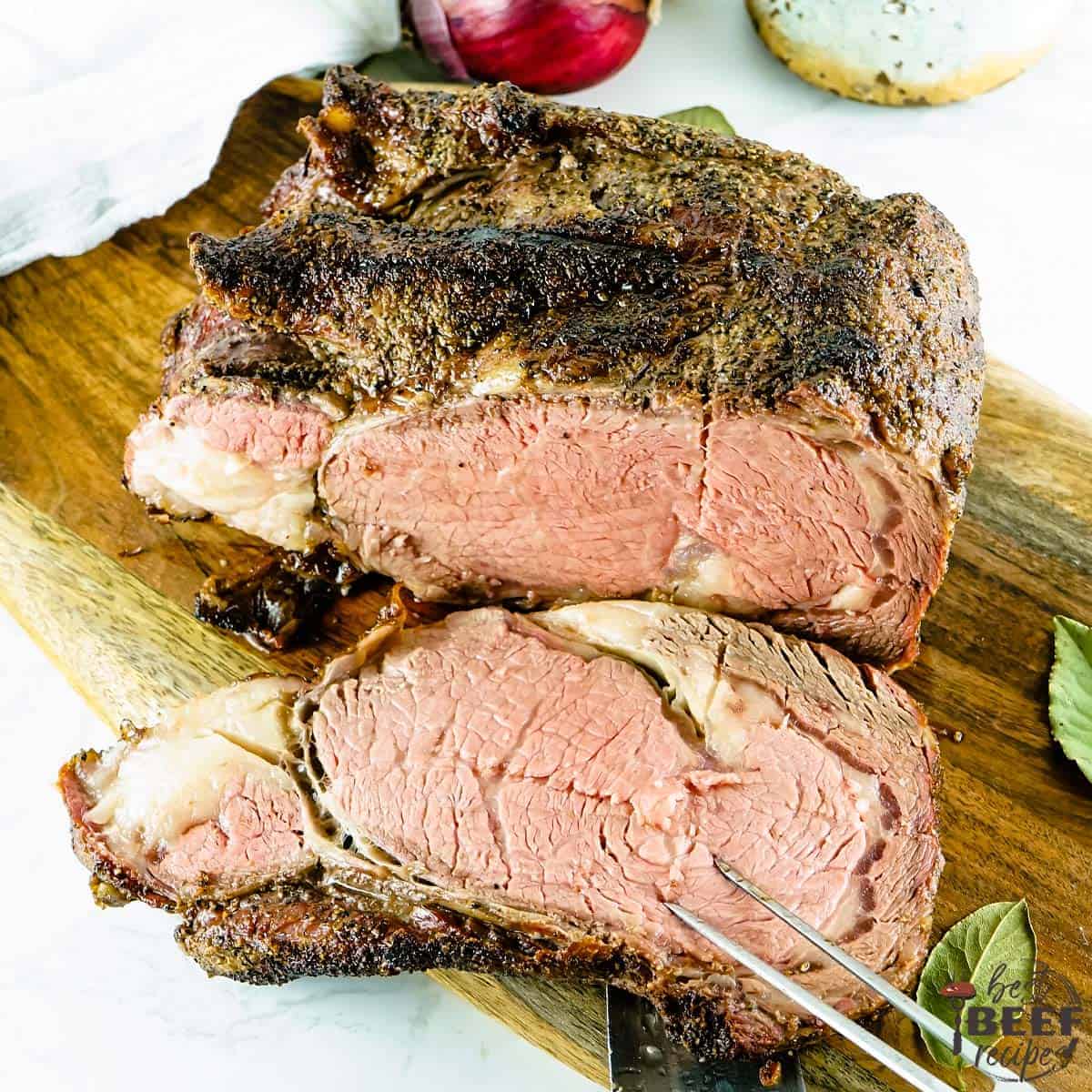 Whole smoked prime rib with a slice cut