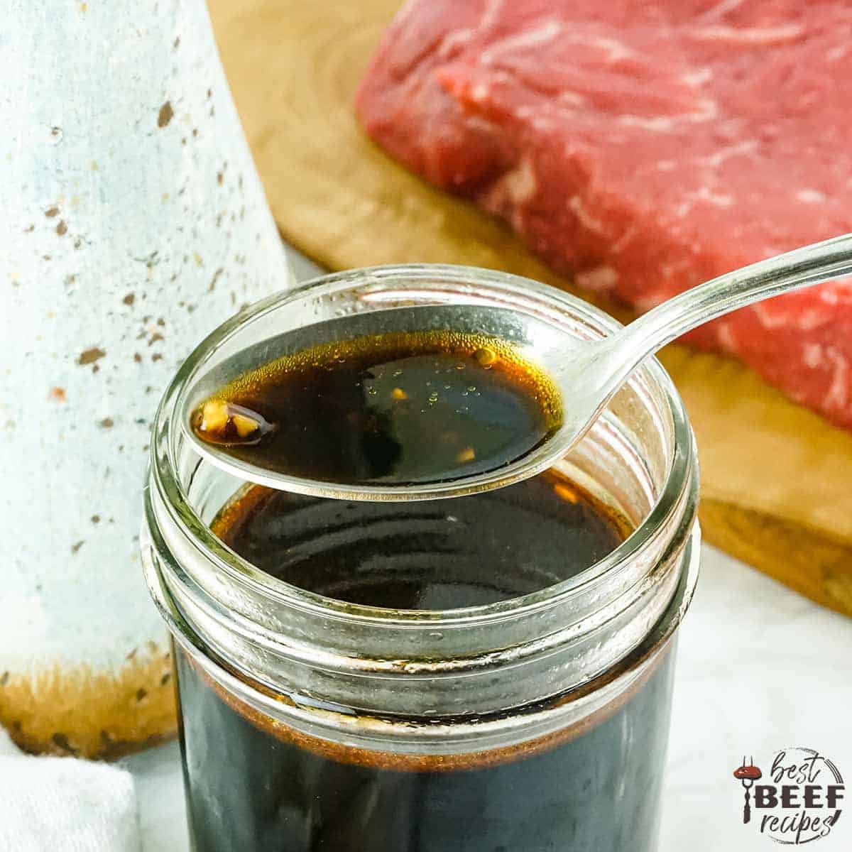 asian steak marinade in a jar with a spoonful of marinade