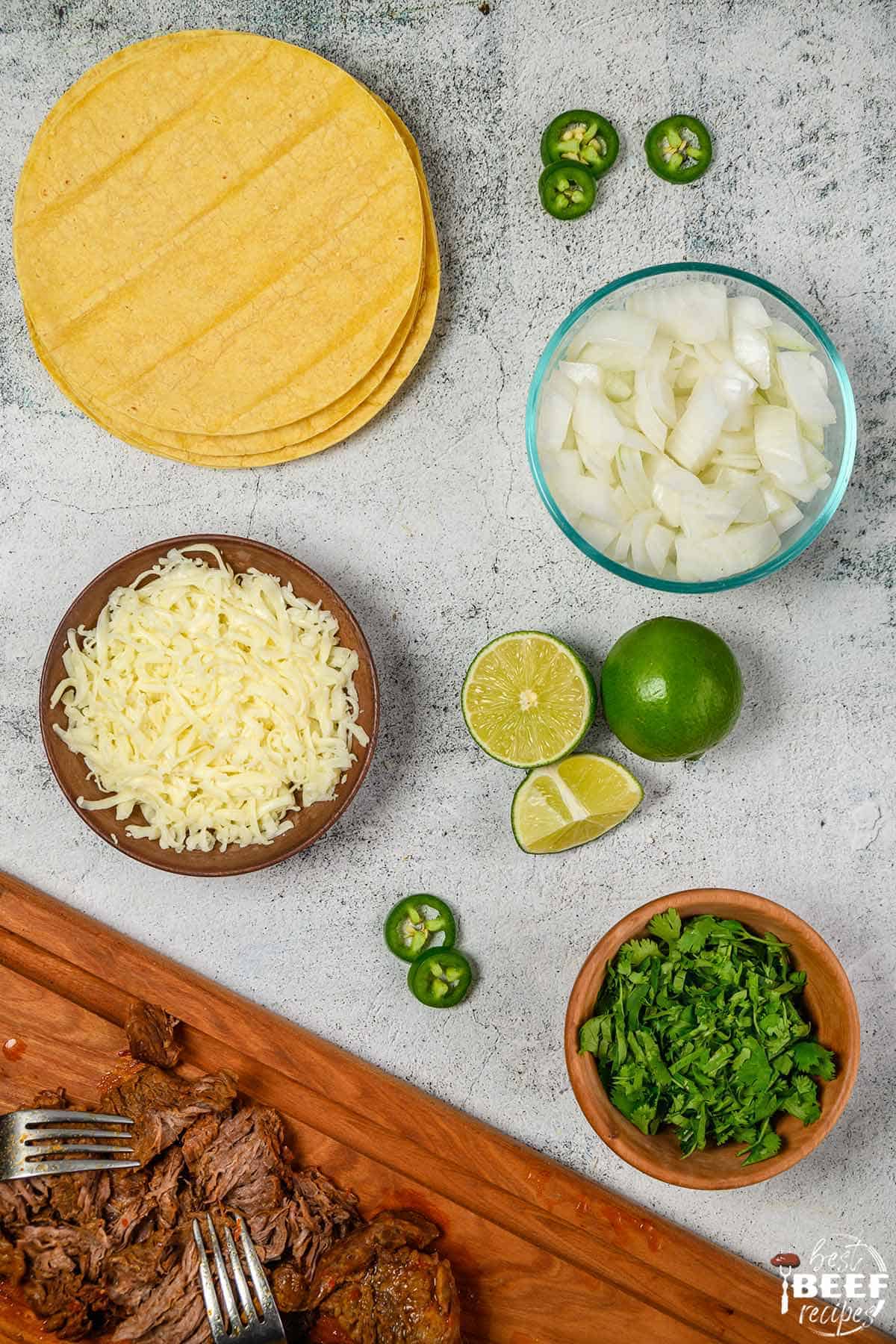 Beef birria tacos ingredients on a white surface