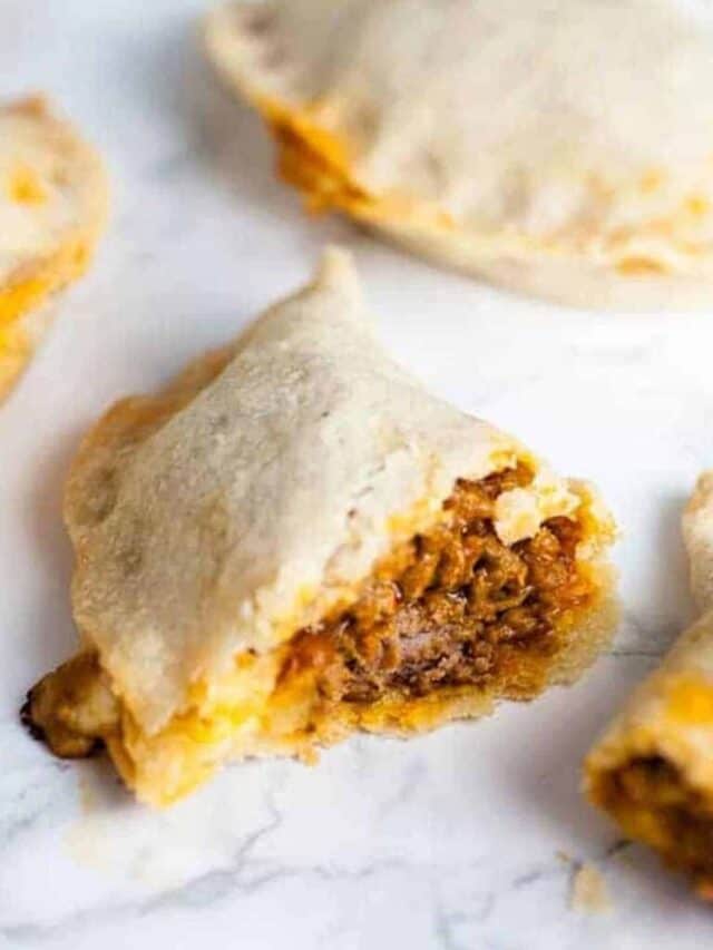 A cut open empanada filled with beef.