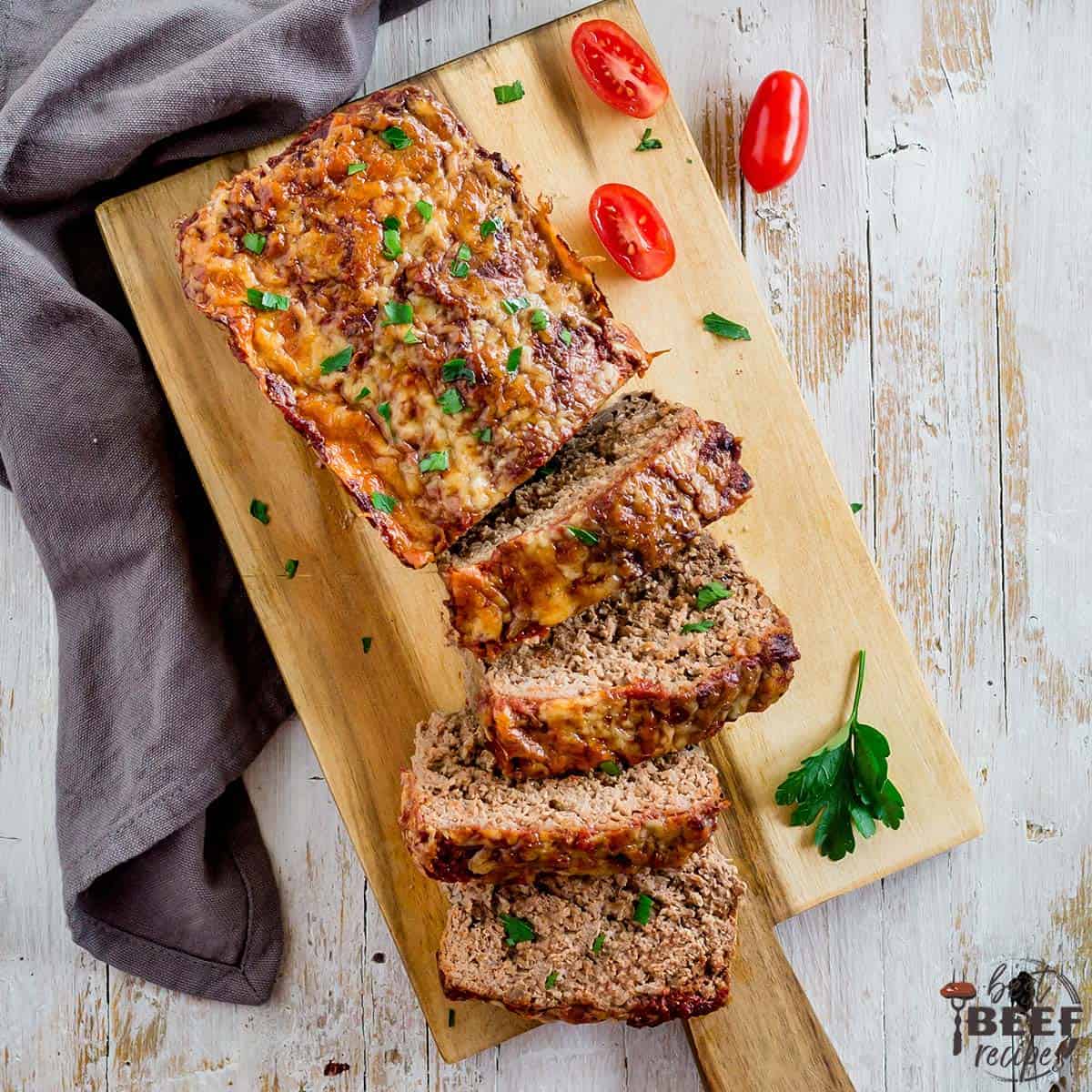 Keto meatloaf on a wooden serving board sliced