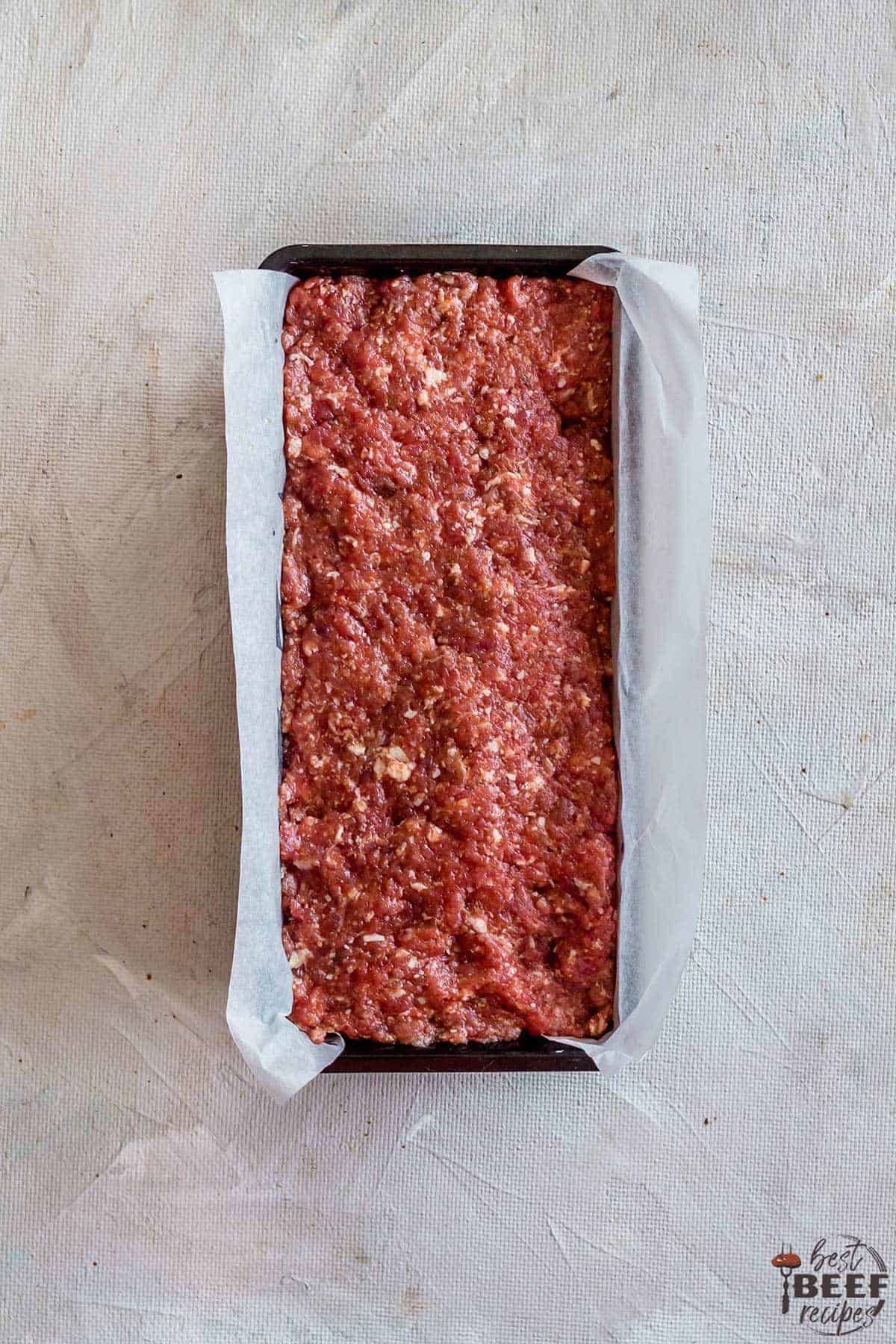 Meatloaf mixture spread into loaf pan