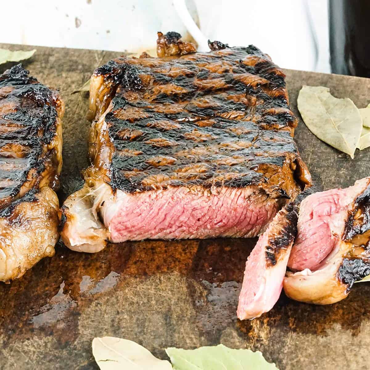 New york strip steak sliced on a cutting board