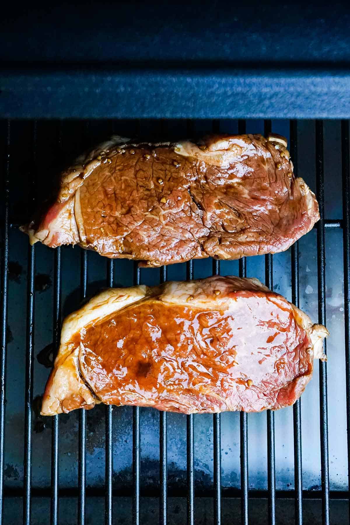 Strip steaks on the grill