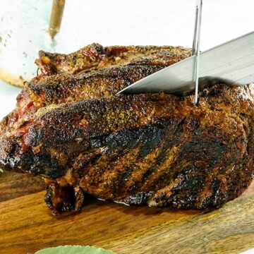 Slicing prime rib seasoned with prime rib rub