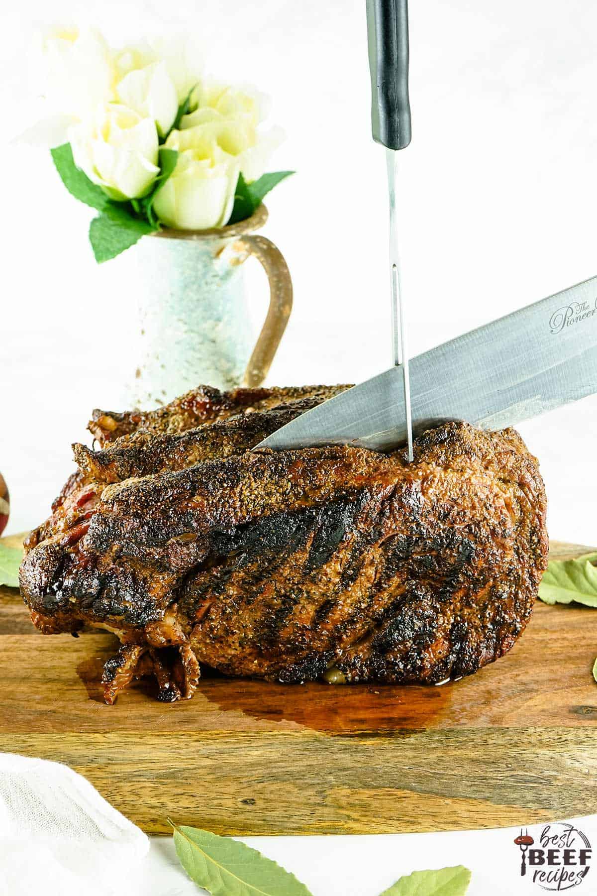 Slicing prime rib seasoned with prime rib rub