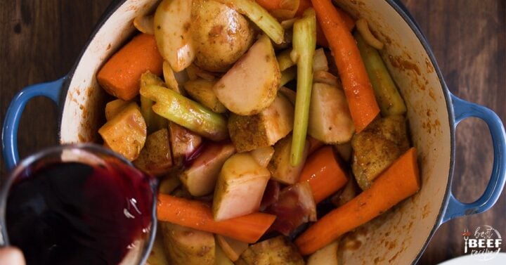 Adding red wine to pan with vegetables