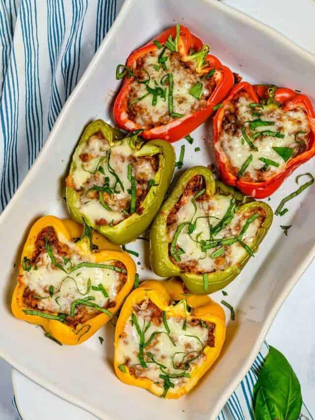 Six keto stuffed bell peppers on a white platter