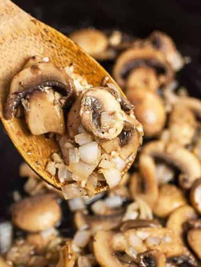 Steakhouse mushrooms in a skillet with a wooden spoon
