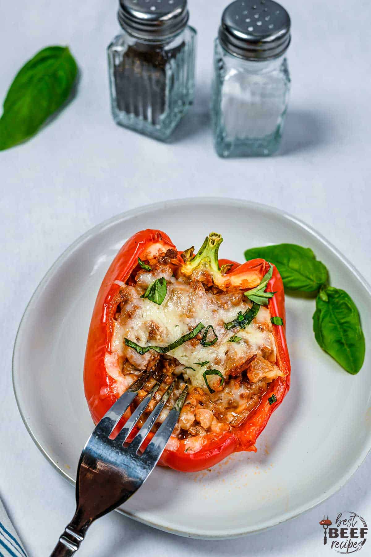 Stuffed bell pepper on a plate with a fork