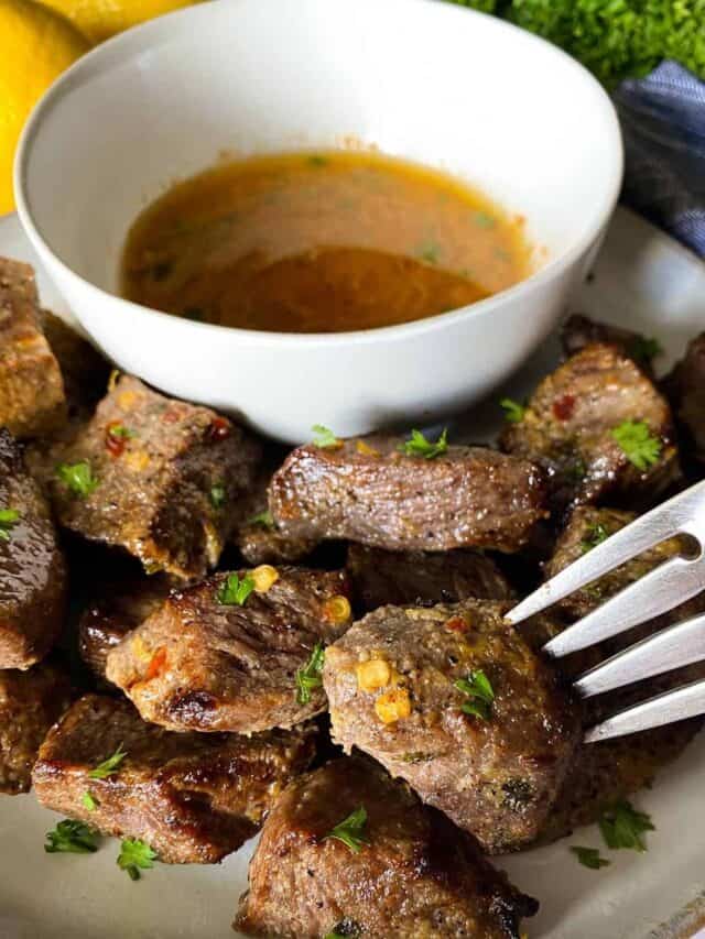 Steak bites on a plate served with cowboy butter.