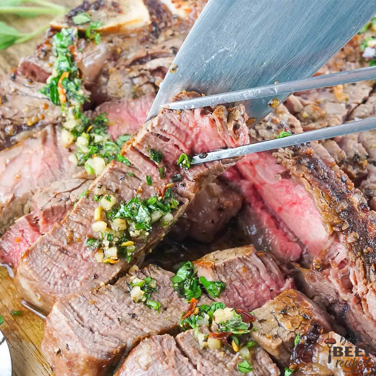 Slicing into grilled porterhouse steak