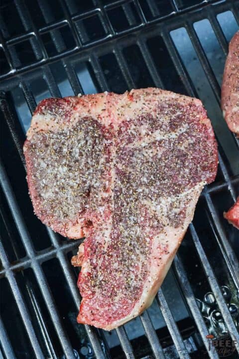 seasoned porterhouse steak on the grill
