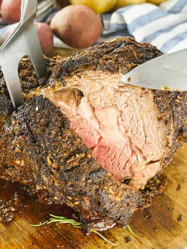 grilled prime rib sliced with a knife and meat fork