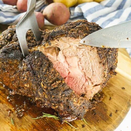 Slicing grilled prime rib on a cutting board