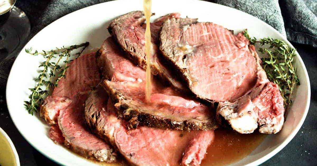 Au jus dripping over sliced prime rib