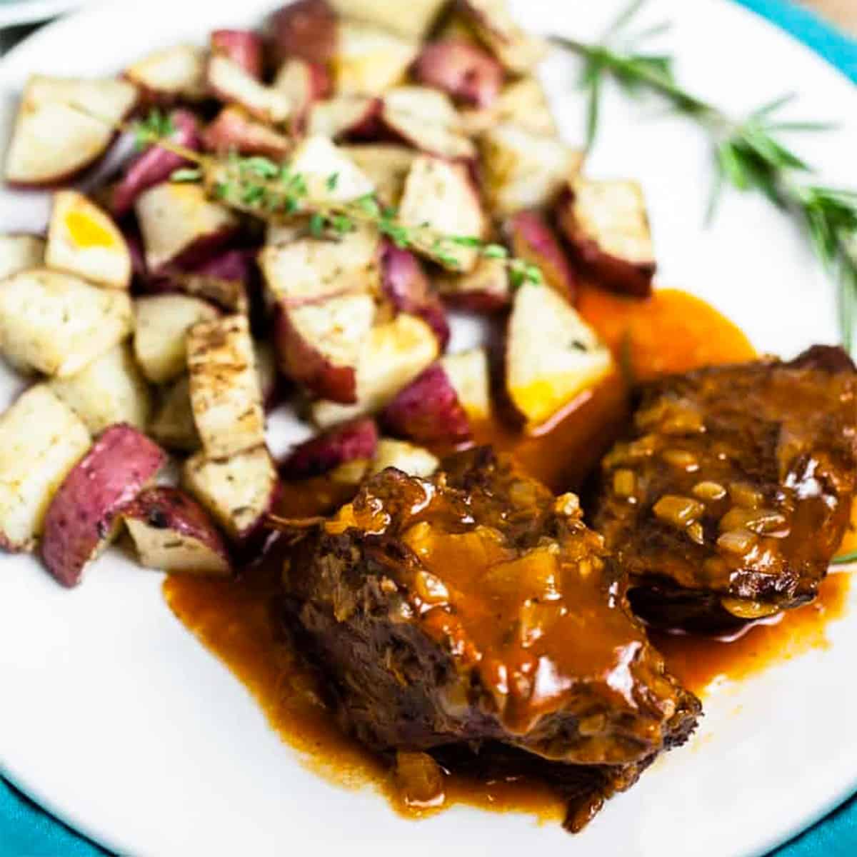 Instant pot pot roast on a plate with potatoes