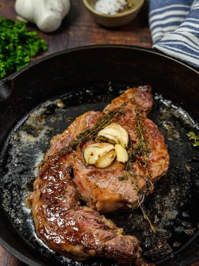 pan seared ribeye in a pan with butter