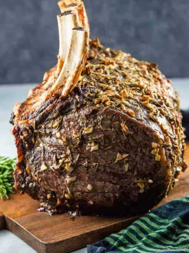 Standing rib roast on a wooden serving board