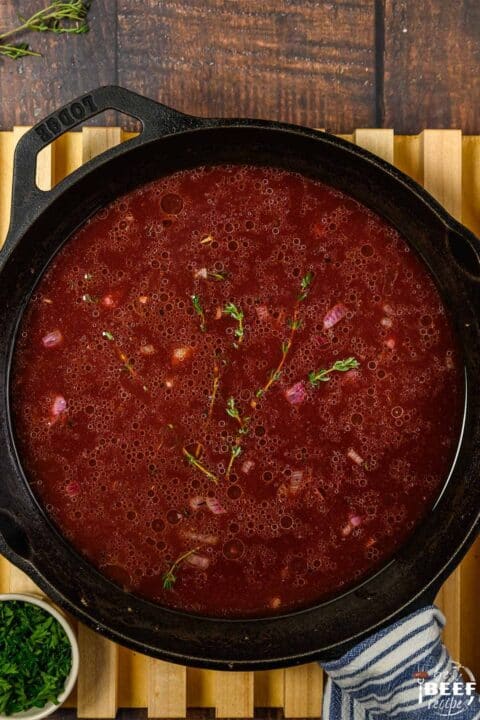Red wine reduction sauce thickening in a pan