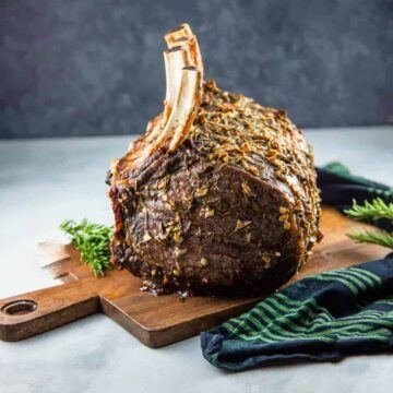 Standing rib roast on a wooden serving board