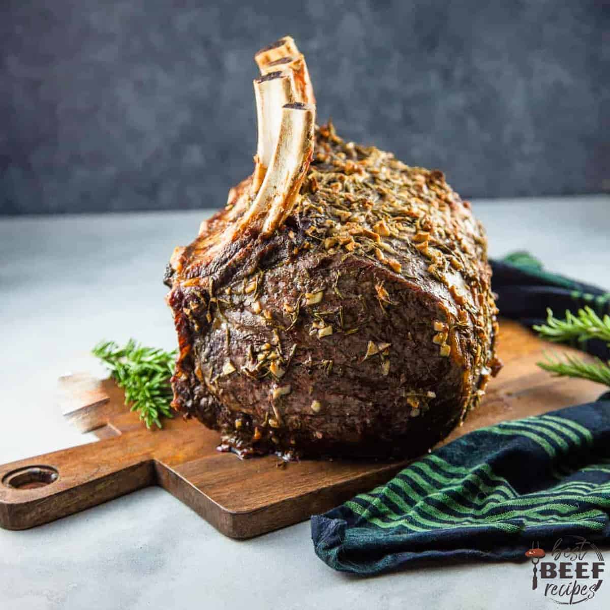 Standing rib roast on a wooden serving board