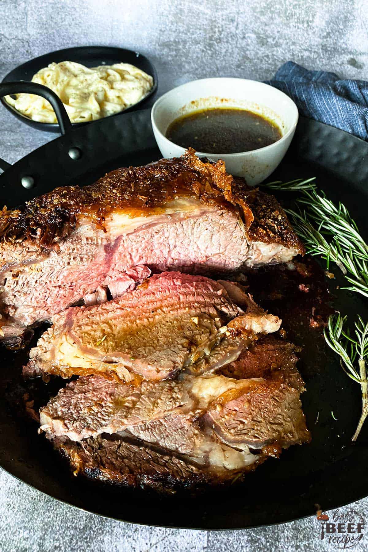 Sliced prime rib on a black plate