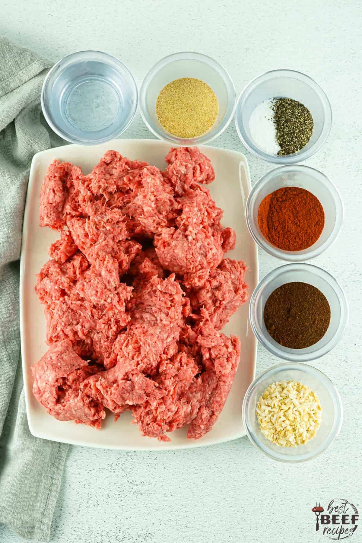 taco meat ingredients on a white surface in bowls
