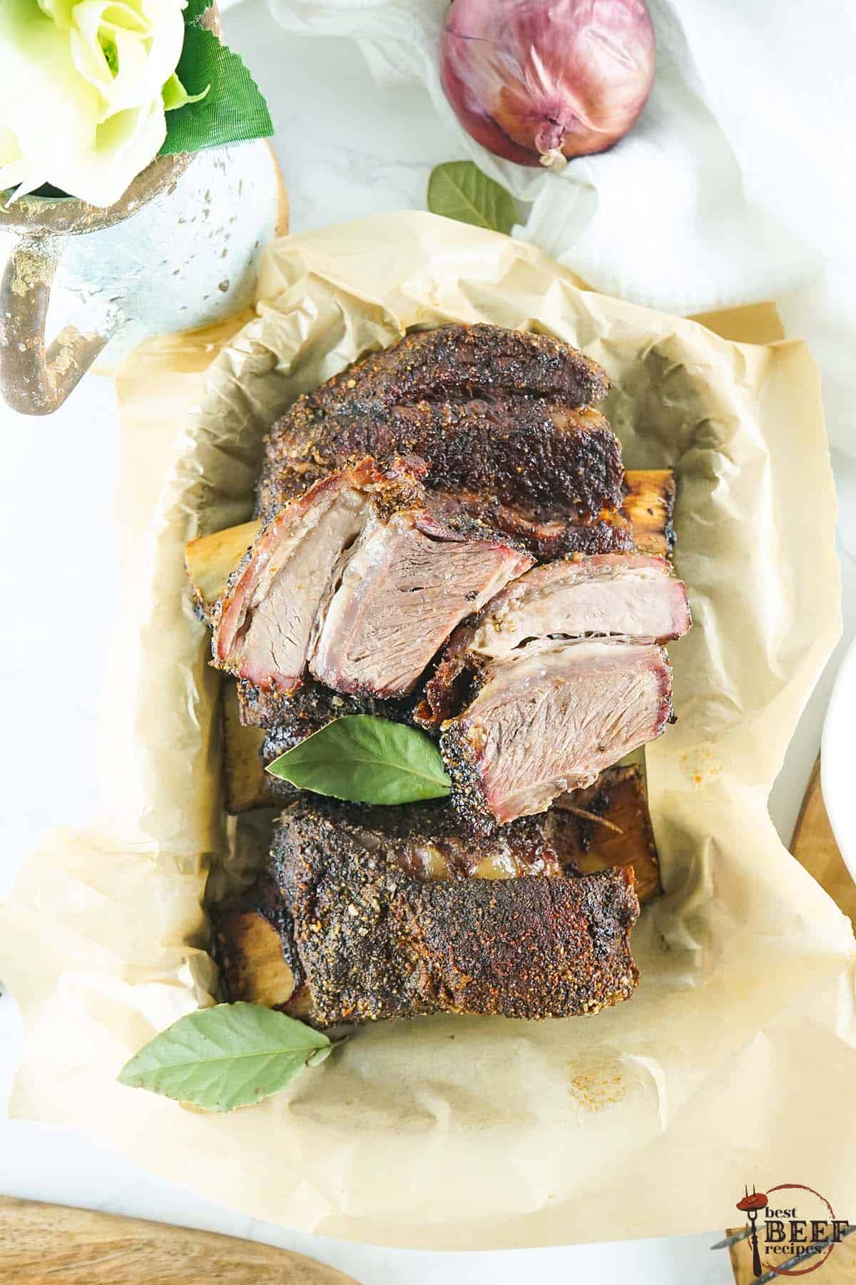 short ribs seasoned with short ribs rub in a basket with parchment paper