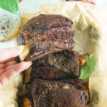 A single smoked short rib on a white plate