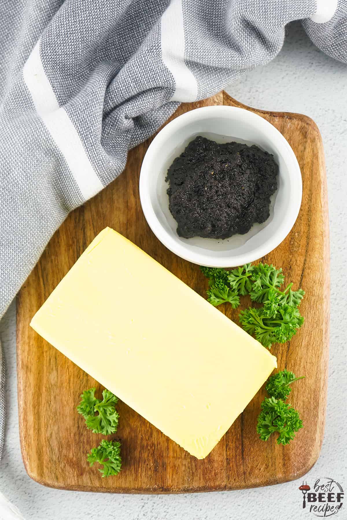 a block of high-quality butter next to truffle pate in a bowl