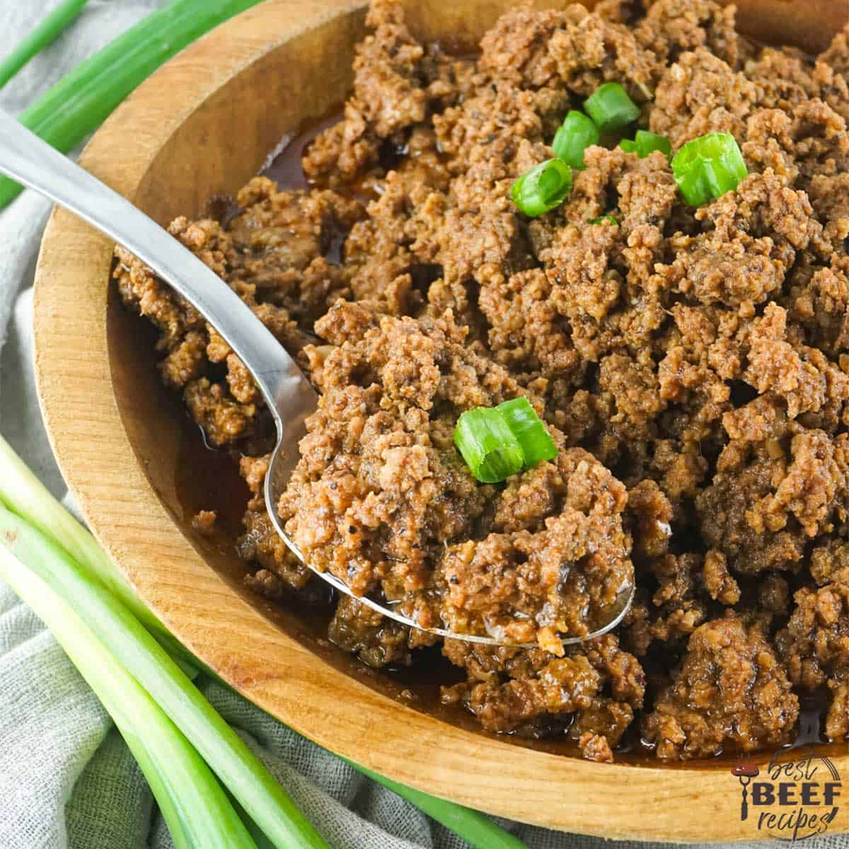 seasoned taco meat in a bowl with a spoon