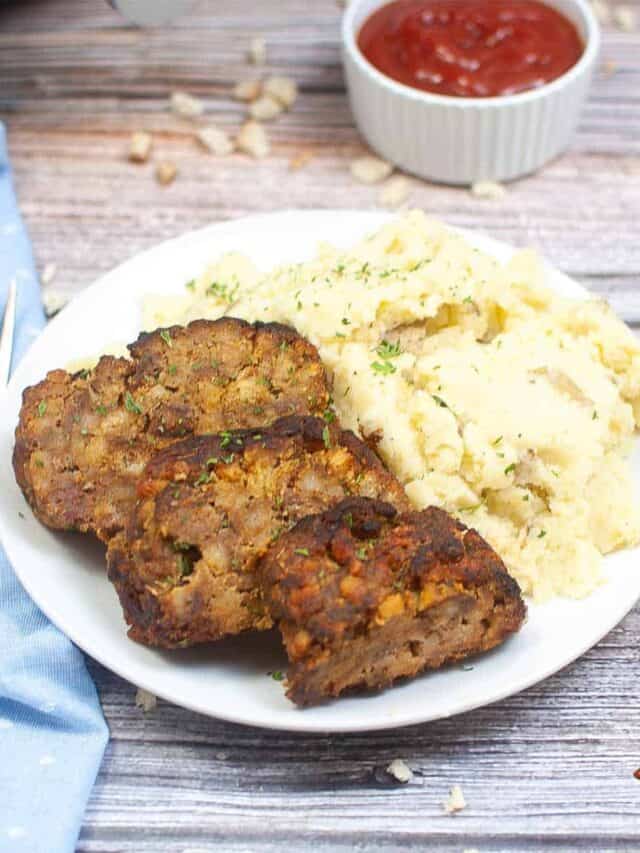 air fryer meatloaf sliced on a plate with mashed potatoes