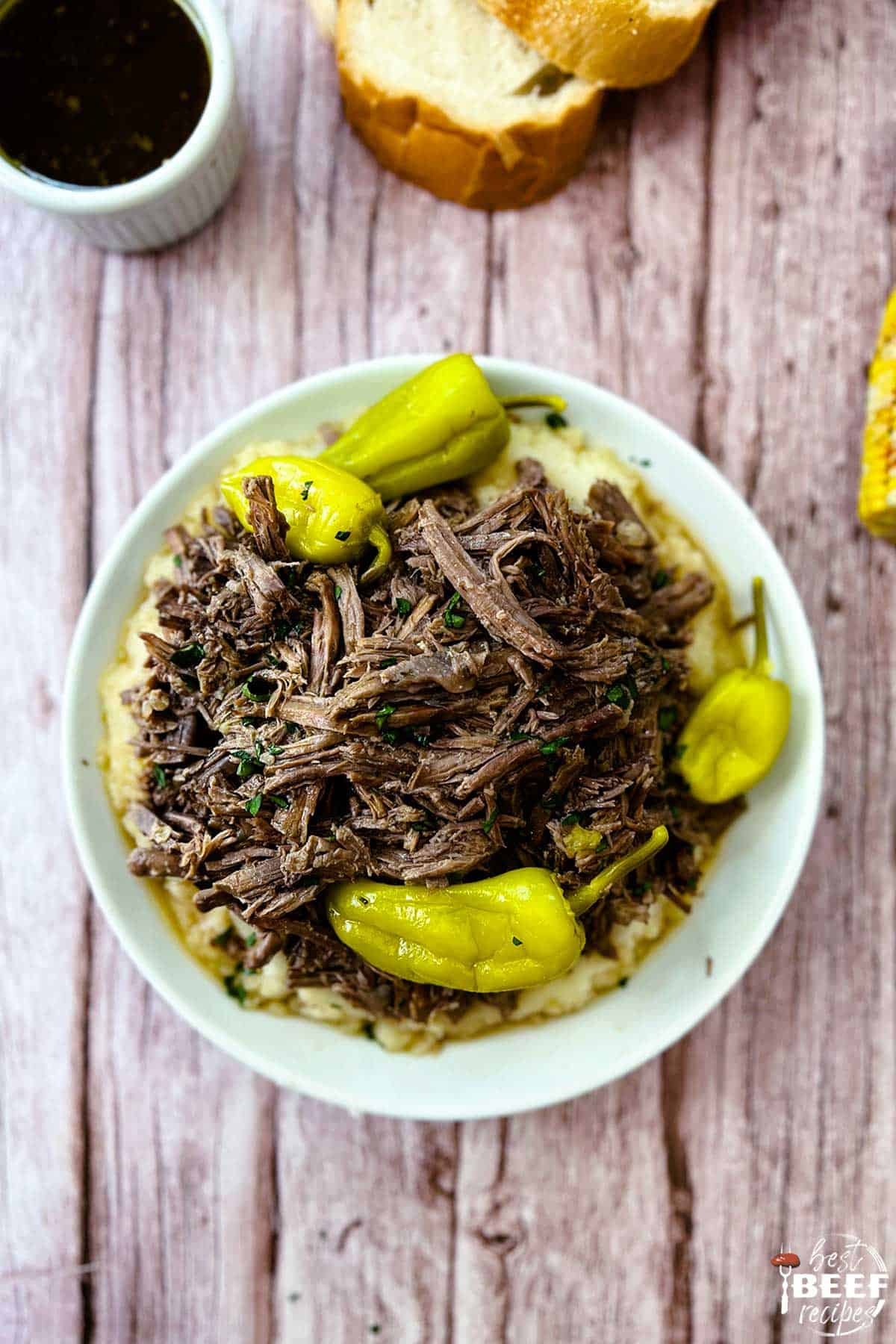 mississippi pot roast on a white plate with pepperoncini peppers