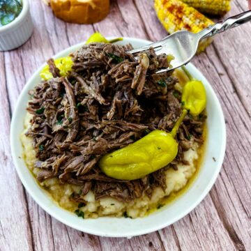 mississippi pot roas with a fork on a white plate