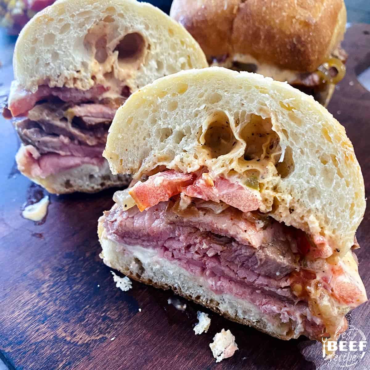 two roast beef sandwiches on a table