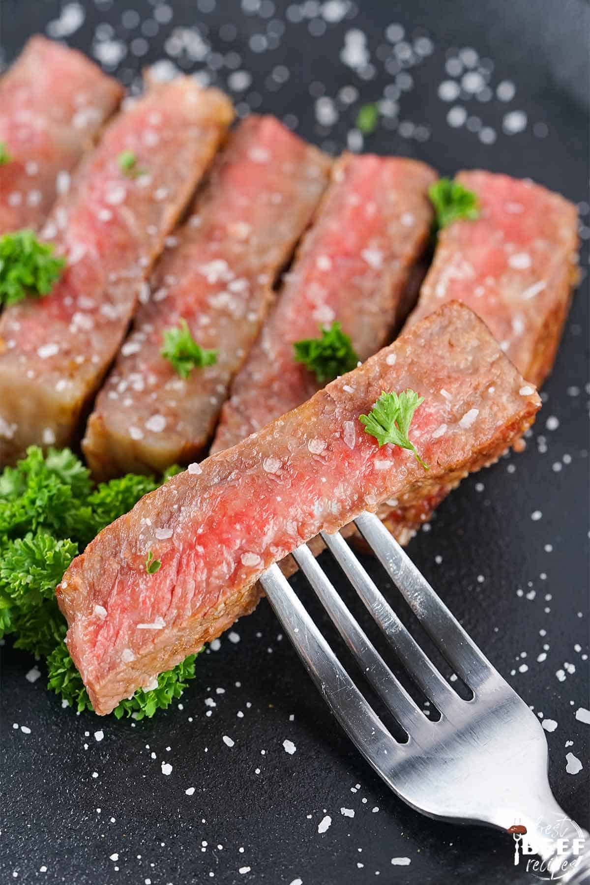 slices of wagyu steak with a fork