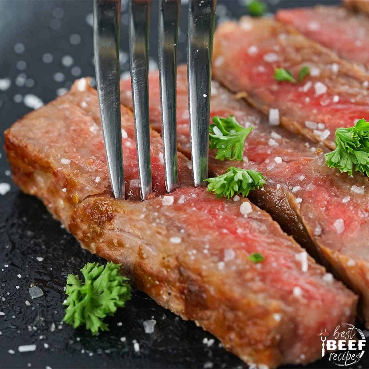 slices of wagyu steak up close with a fork
