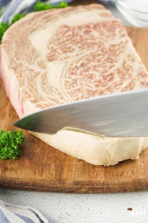 cutting fat from wagyu steak