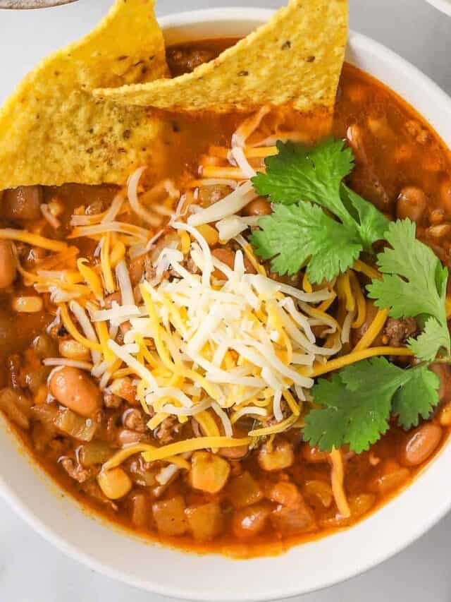taco soup in a white bowl with tortilla chips