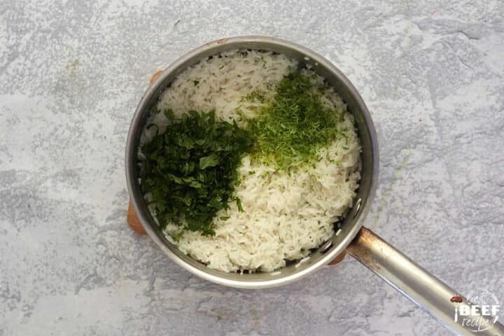 mixing cilantro and lime into the rice