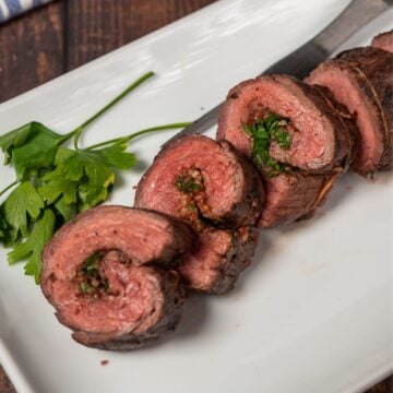 Beef roulade sliced on a plate up close