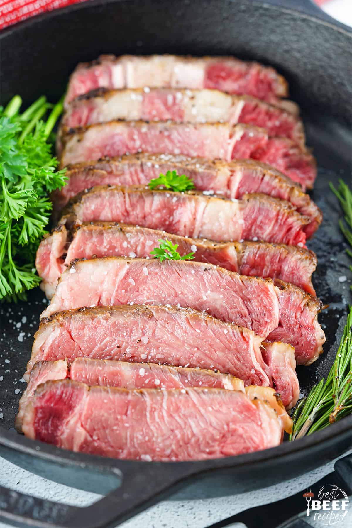 sliced sous vide ribeye in a cast iron pan