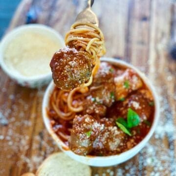 bowl of spaghetti meat sauce with a fork and meatball