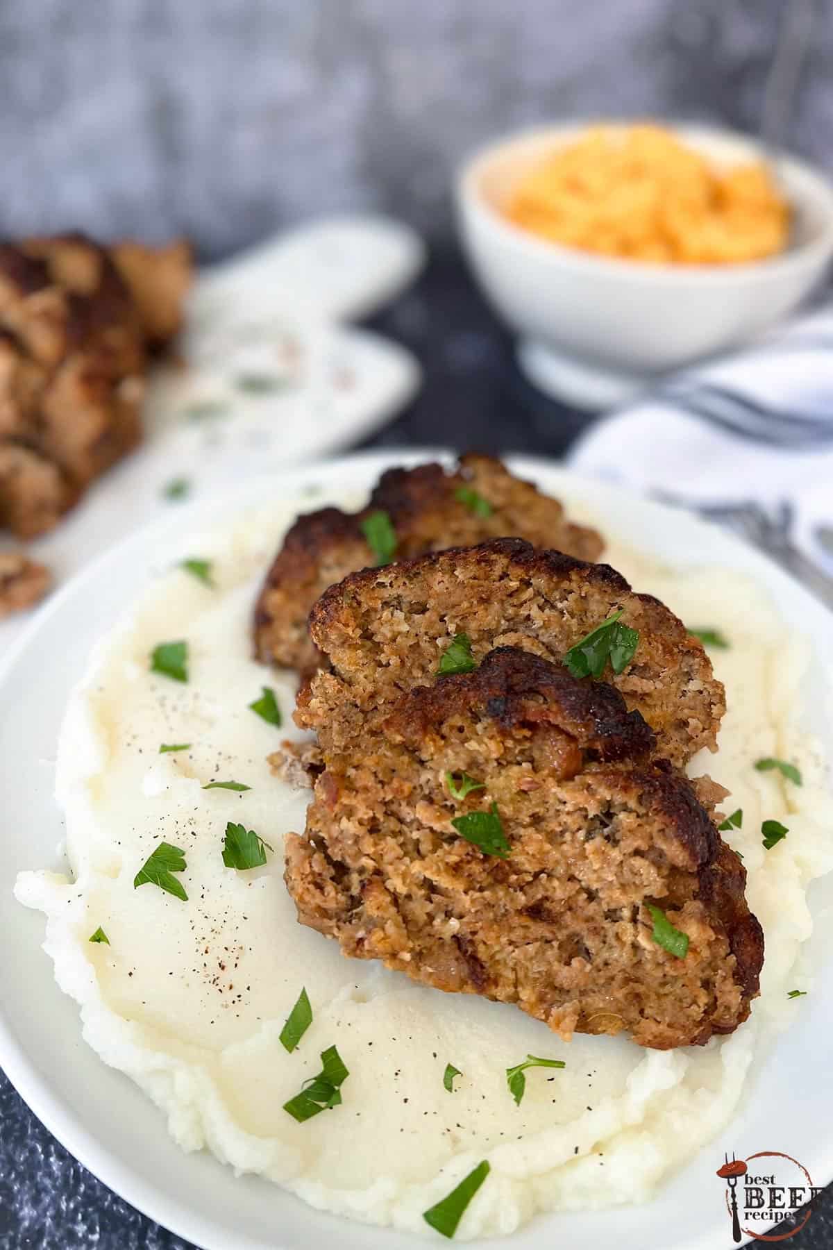 air fryer meatloaf sliced over mashed potatoes on a plate