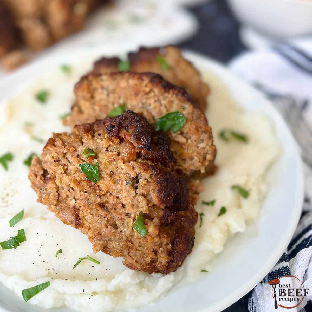 three slices of air fried meatloaf over mashed potatoes